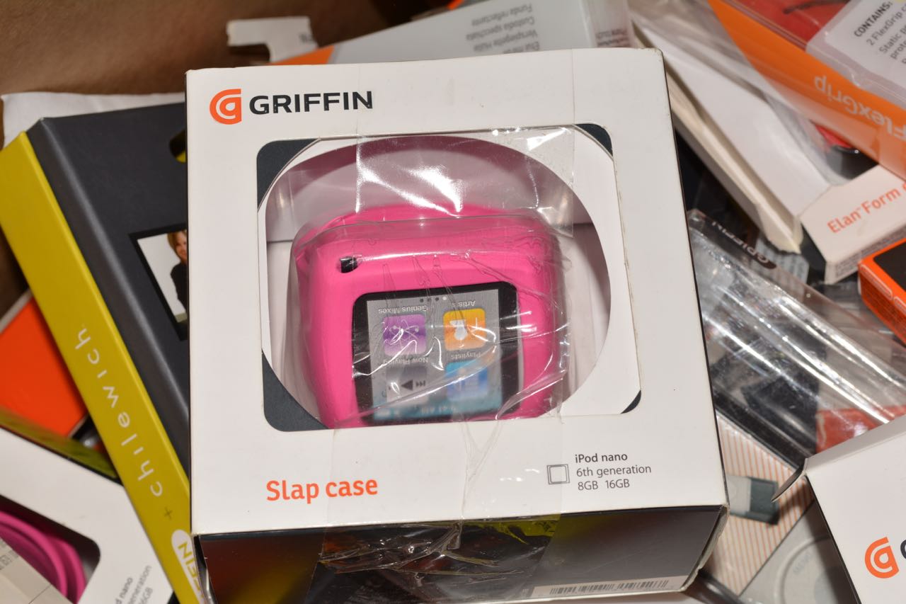 Assorted Griffin Mobile Device Accessories - Bins may include but are not limited to: Air Strap holders for iPad (1st generation), Standle Display & Carry Case for iPad, Outfit Ice for iPad, Slap Case for iPod nano (2nd generation), Elan Passport Graphite Cases for iPhone (1st generation) iPod Nano (2nd generation) silicone cases, Tune Buds (earphones), hard shell cases for iPod Touch (2nd gen), ultra thin protection covers, cases with armband &amp; clip for iPod, iPod and iPhone armbands, leather slim sleeves for iPod Nano, iPhone cases (3G)